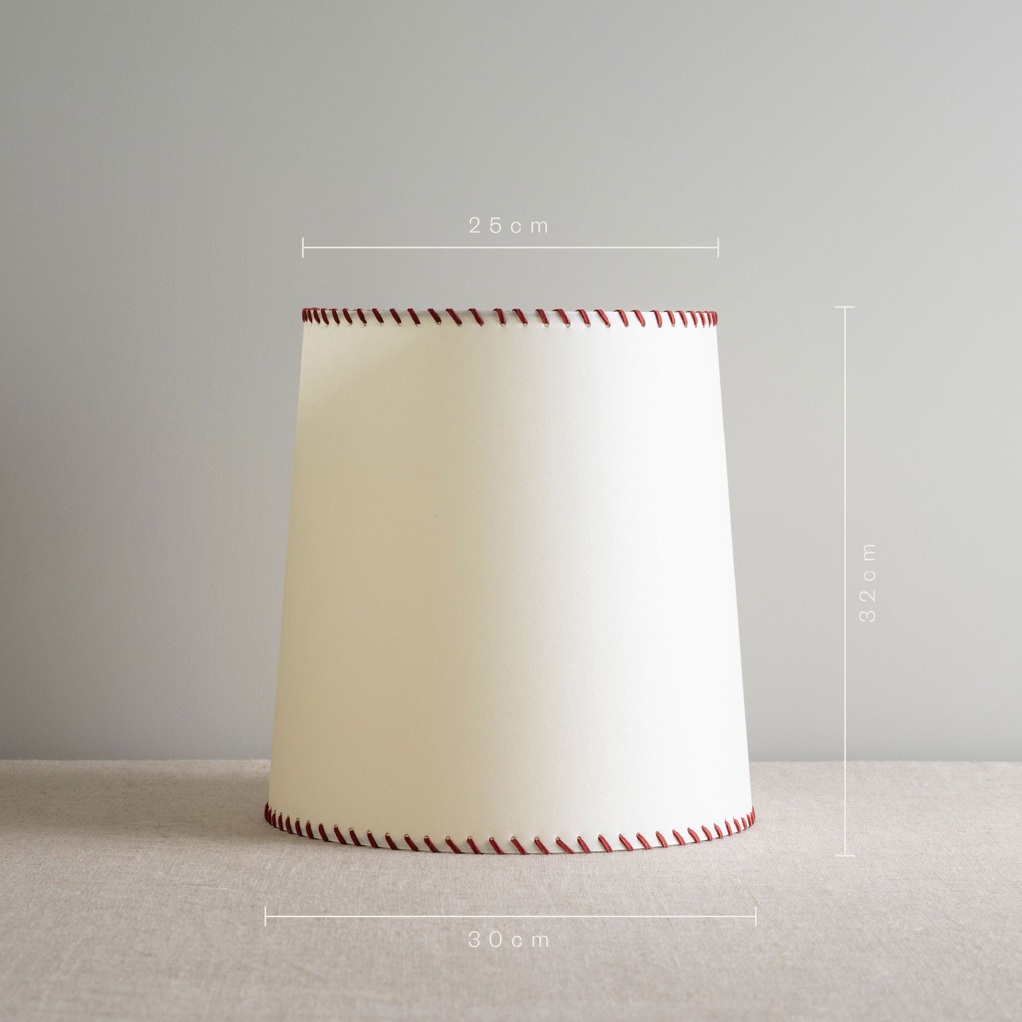  Modern white lamp featuring stylish red stitching for a touch of elegance. With Measurements in 'cm' 