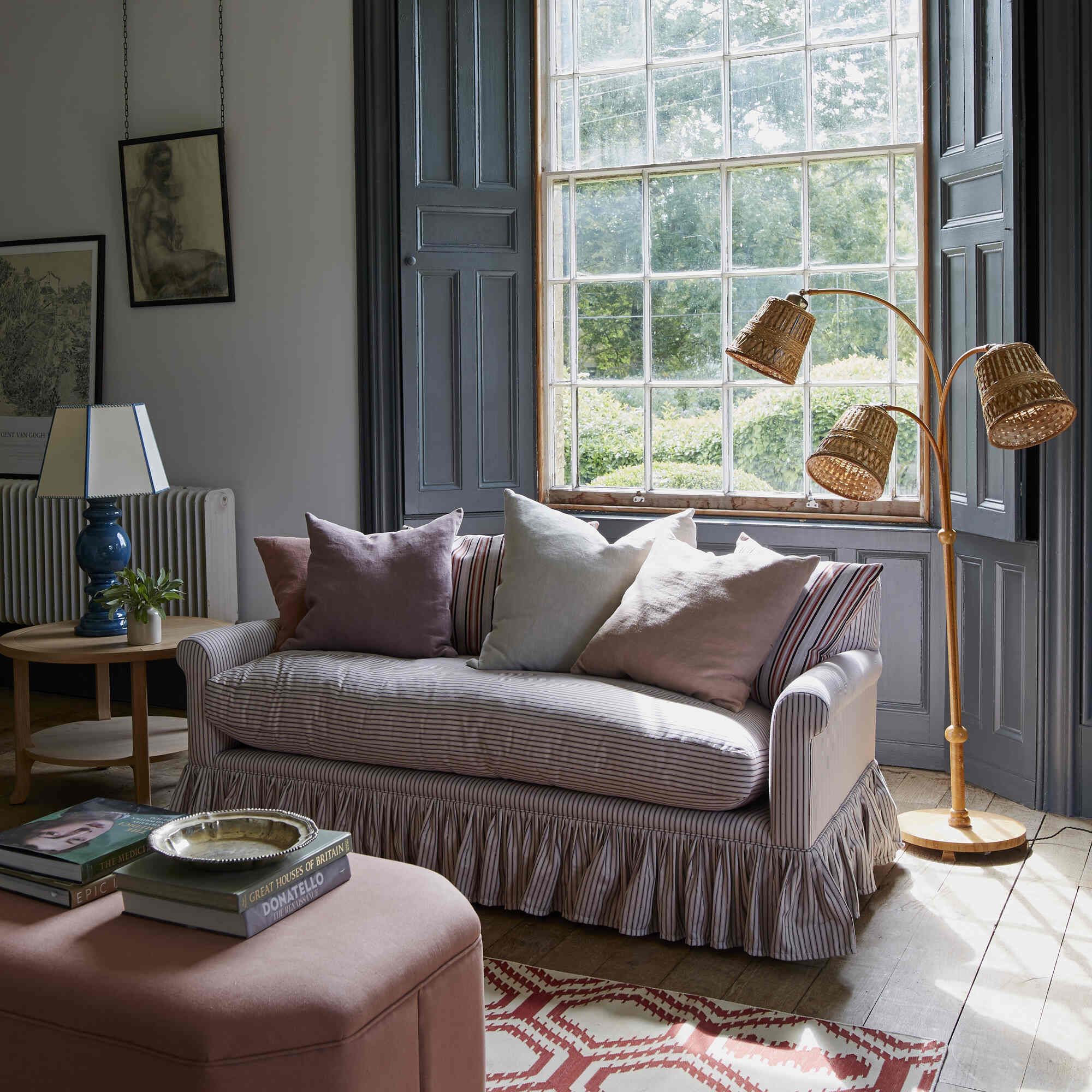  Curtain Call 2 Seater Sofa styled with plush cushions in a sunlit room by Nicola Harding. 
