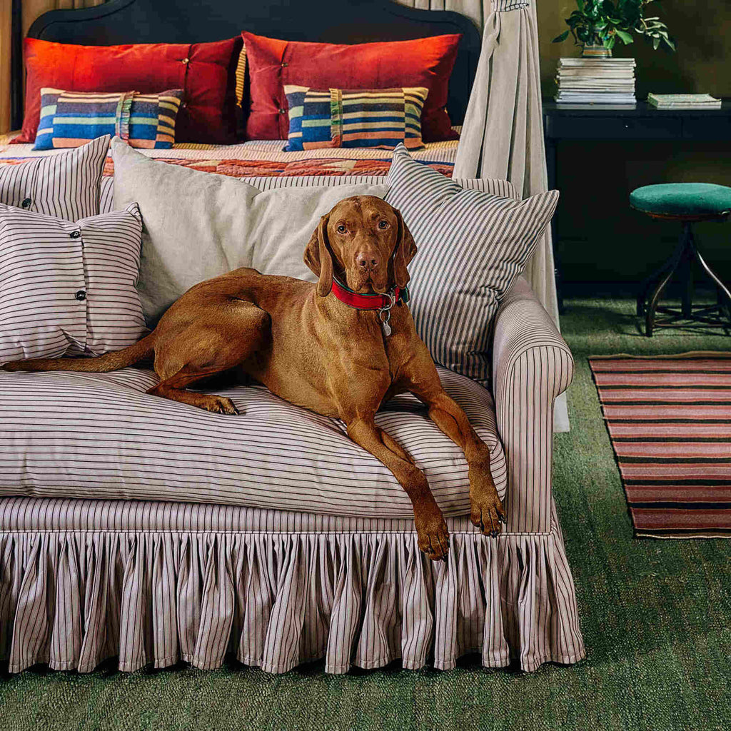  Nicola Harding & Co relaxed linen sofa with a playful skirt detail in a residential setting. 