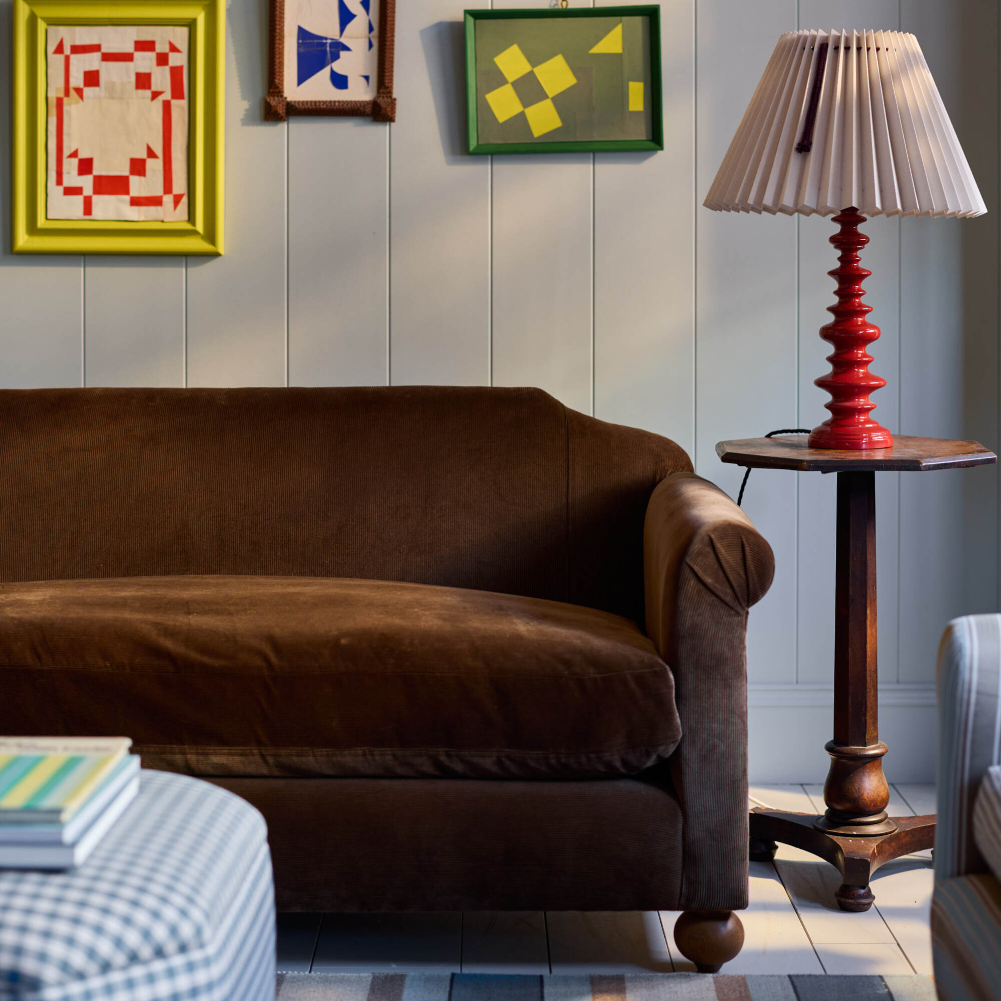  Nicola Harding interiors Dolittle sofa styled with a red bedside table style side lamp 