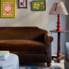 Nicola Harding interiors Dolittle sofa styled with a red bedside table style side lamp