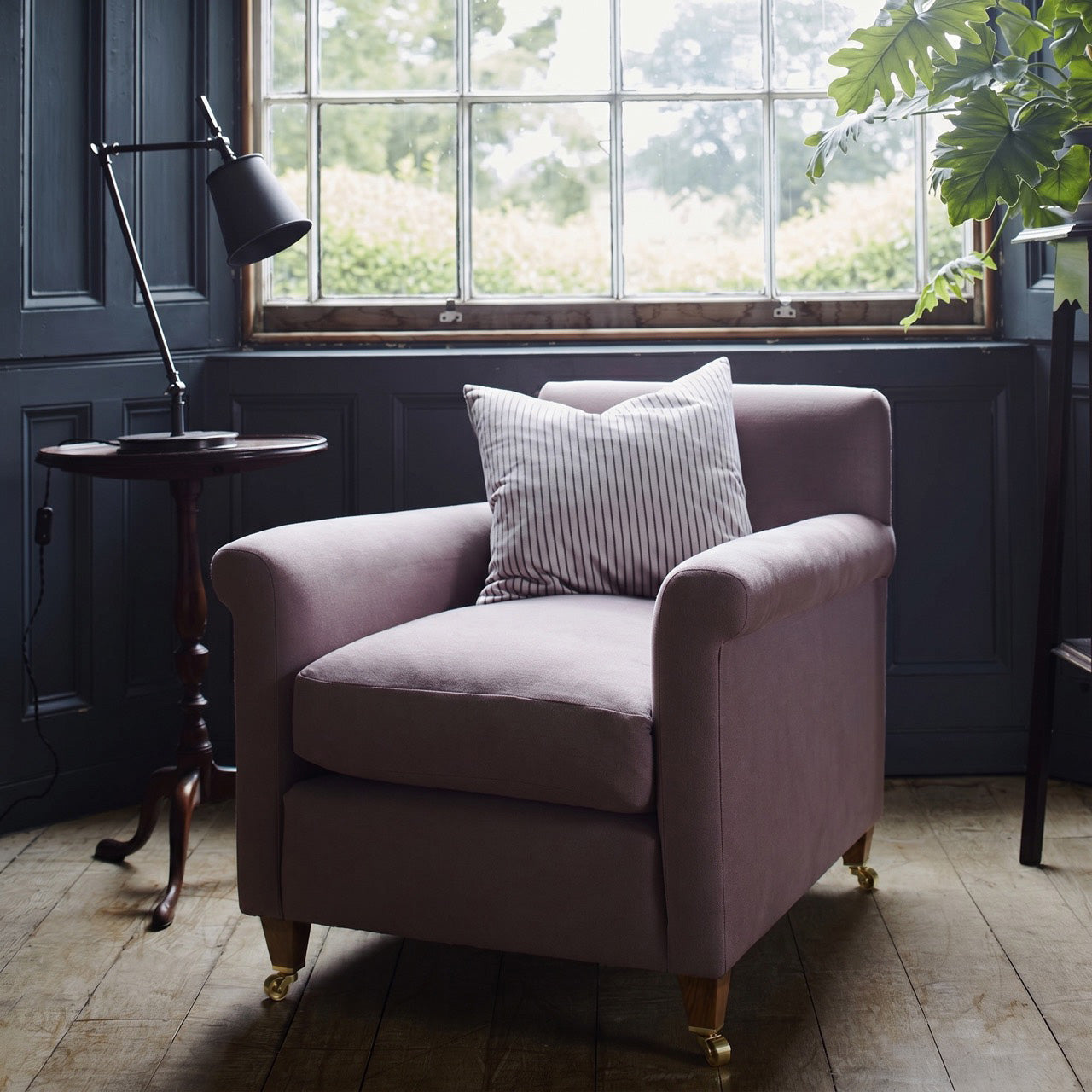  Idler Armchair styled beside a window with a cushion and a table lamp - Nicola Harding interior 