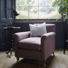 Idler Armchair styled beside a window with a cushion and a table lamp - Nicola Harding interior