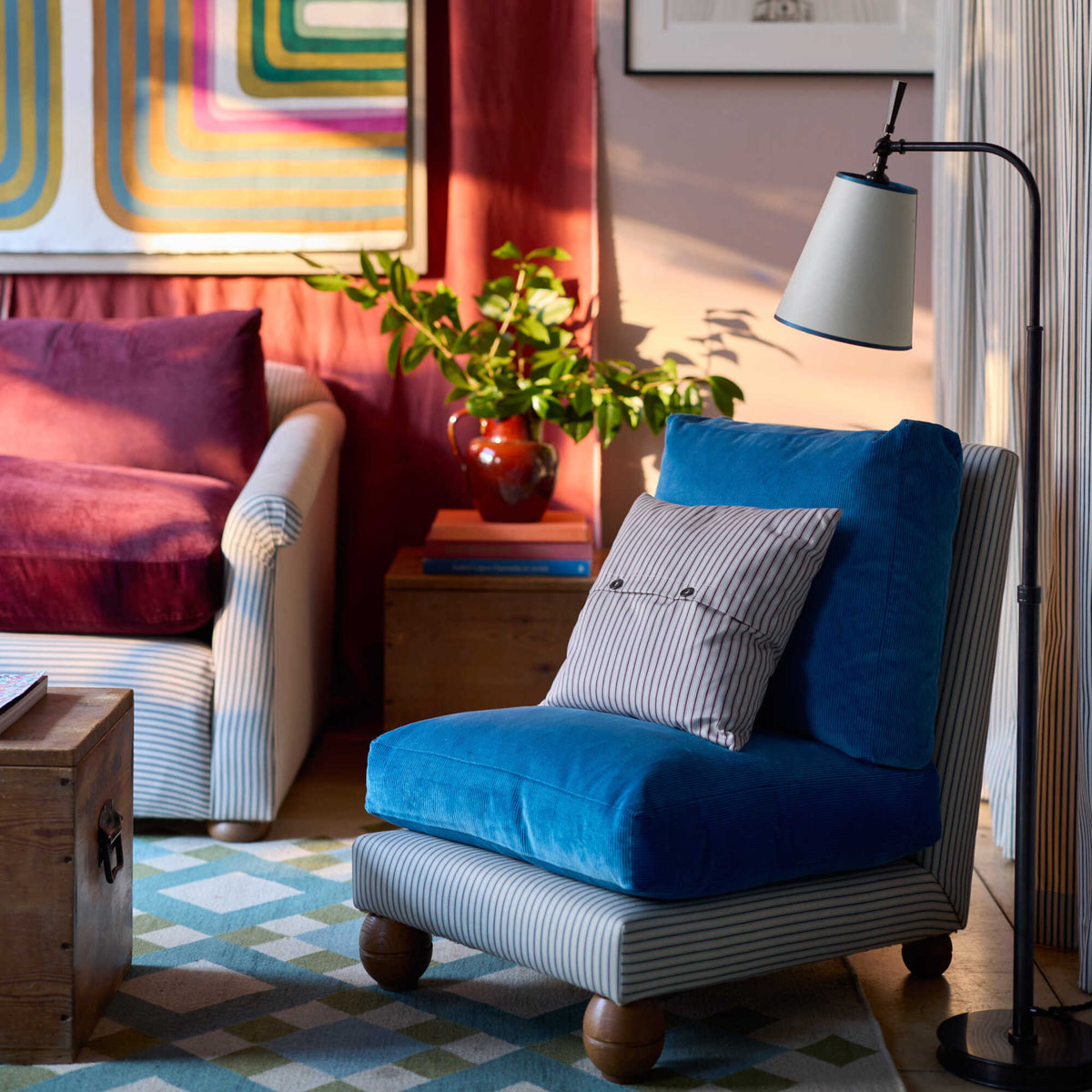 Perch Armchair styled with cushions and floor lamp by Nicola Harding Interiors