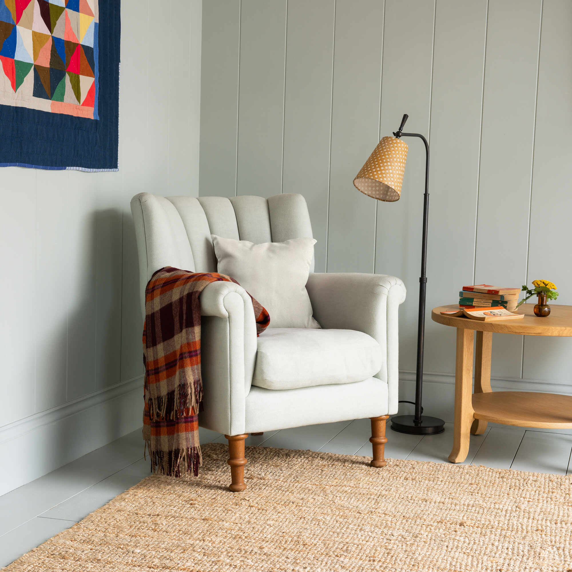  Time Out Armchair styled with a throw blanket and floor lamp in a cozy corner by Nicola Harding. 