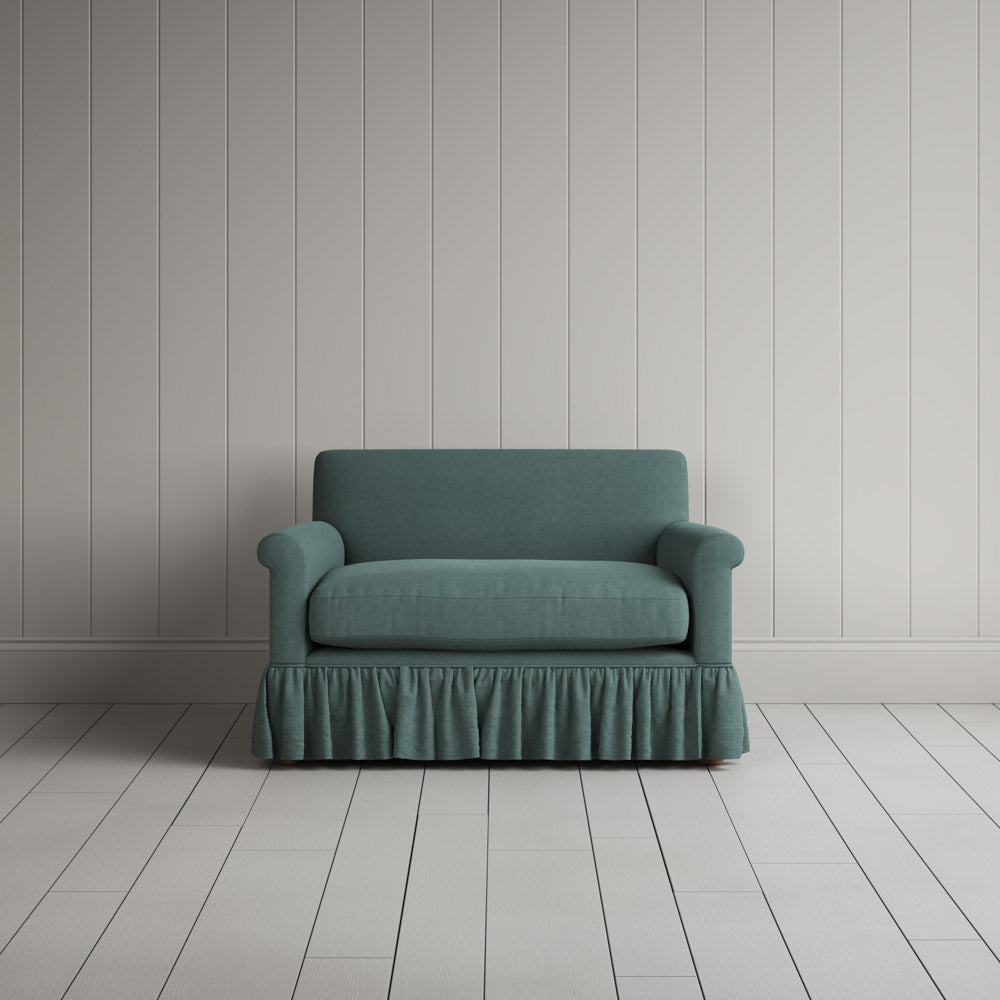  Curtain Call Love Seat playful skirted design in laidback linen mineral, front studio view. 