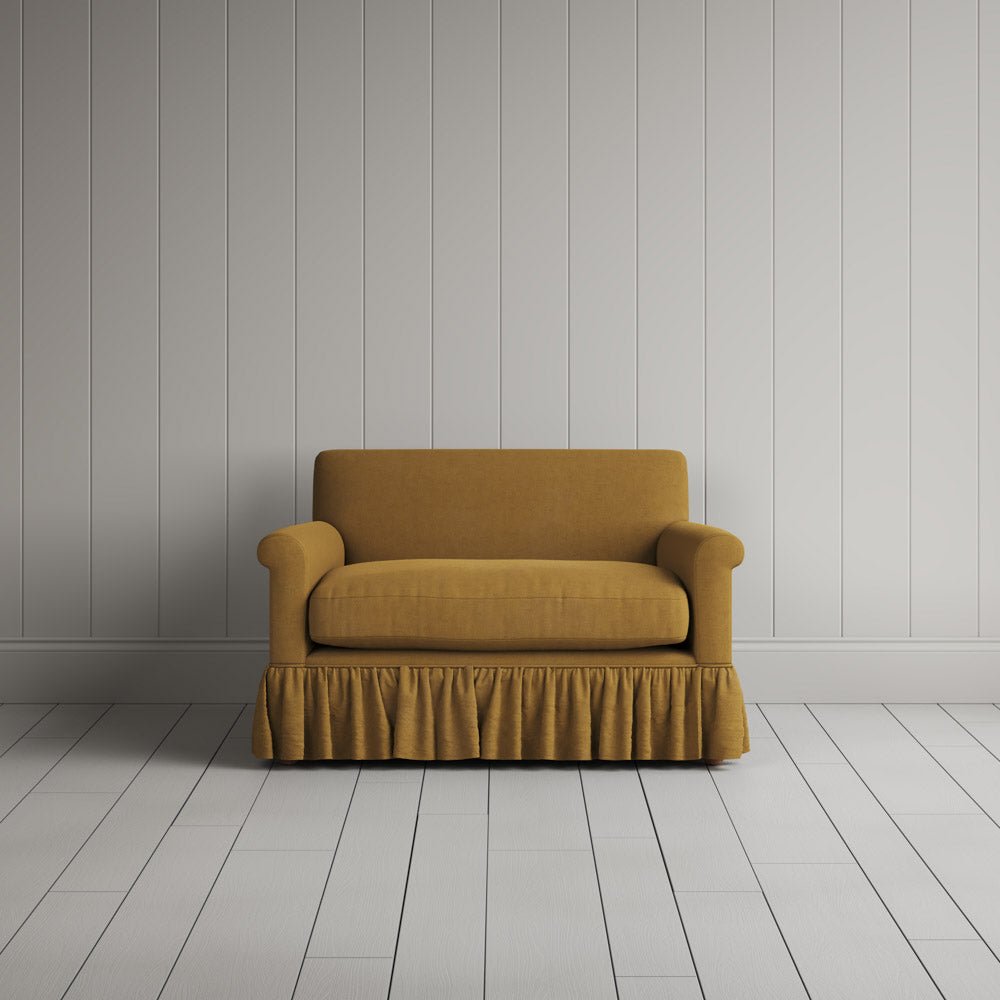  Curtain Call Love Seat playful skirted design in laidback linen ochre, front studio view. 