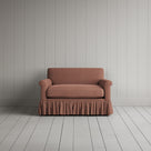 Curtain Call Love Seat playful skirted design in laidback linen roseberry, front studio view.