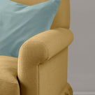 Close-up of premium linen upholstery on a Nicola Harding love seat with a decorative accent cushion.