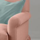 Detail of the scroll armrest on the Roseberry Curtain Call sofa by NiX styled with a contrasting green cushion.