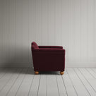 Side profile of the Cherry red corduroy Dolittle love seat