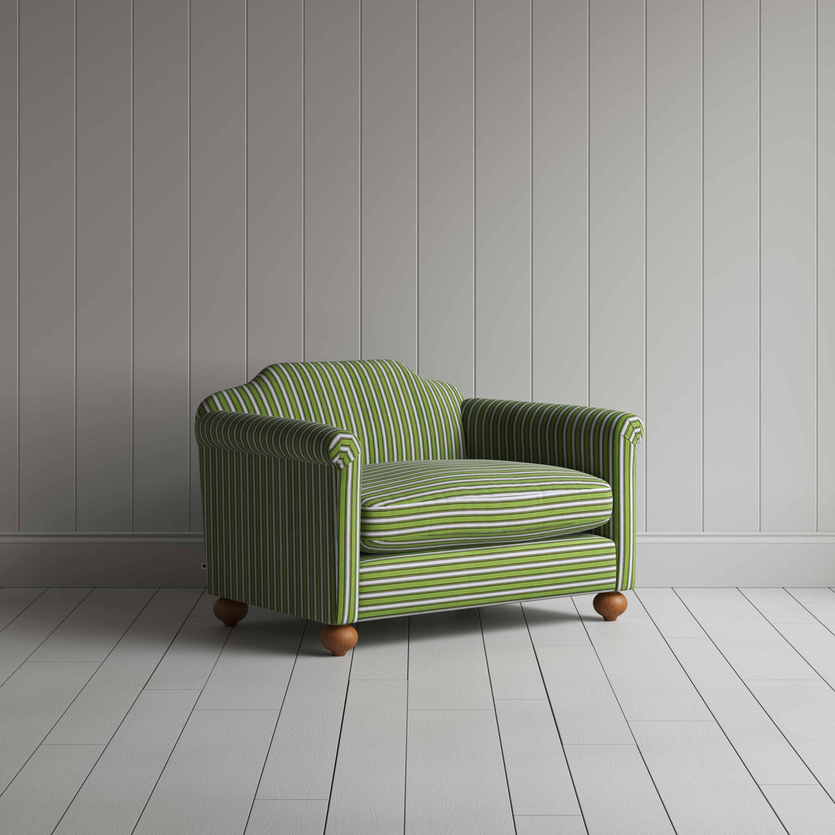 Green and white striped sofa on wooden floor.