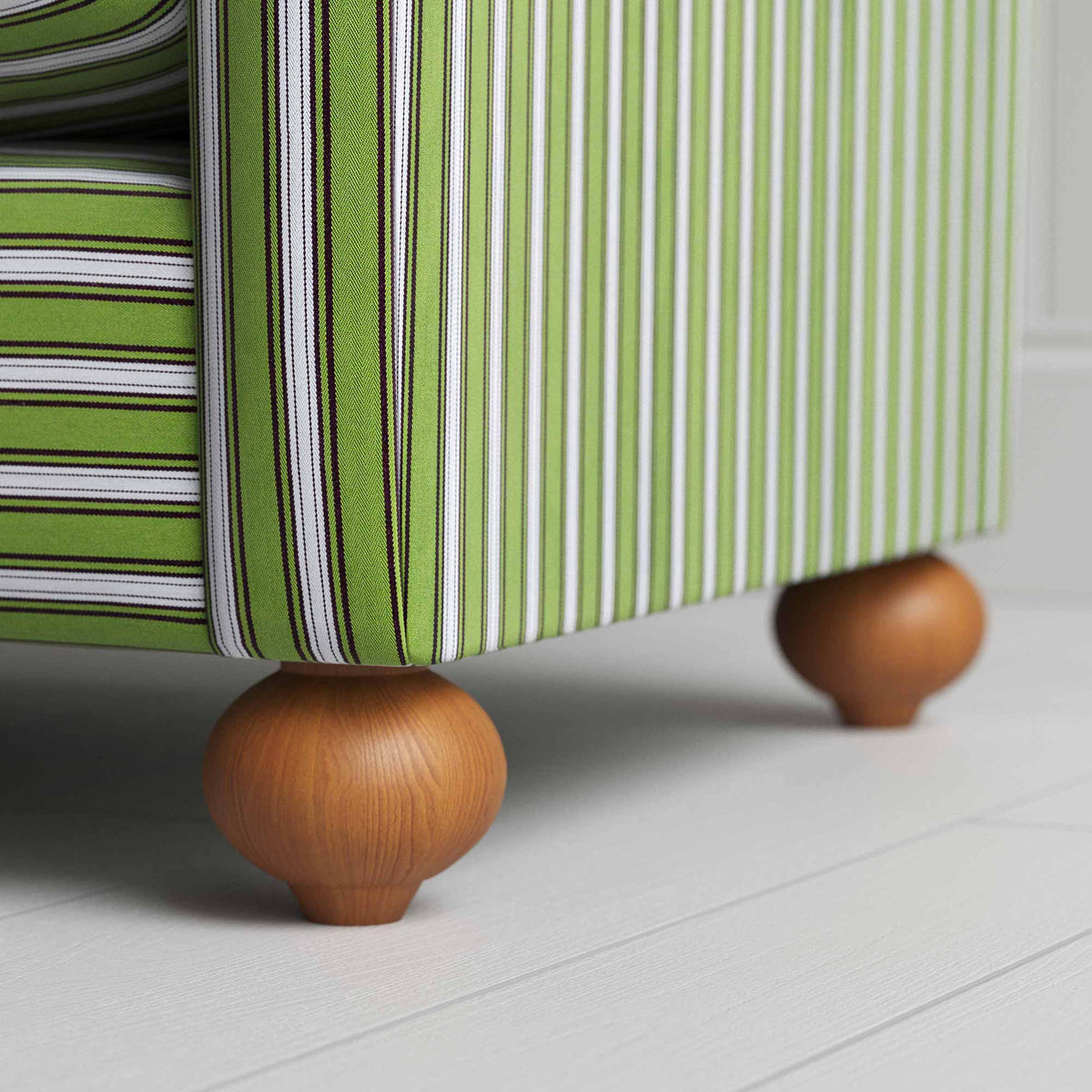 A close up of white and green stripped sofa.