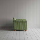 A white and green stripped sofa against the wall.