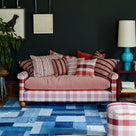 Elegant sofa in a beautifully designed living room, complemented with cushions by Nicola Harding & Co.