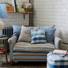 Beautifully designed loveseat by Nicola Harding & Co., adorned with elegant cushions for a touch of sophistication.