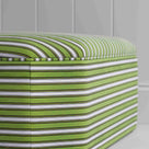 Zoomed stylish green and white striped ottoman, ideal for enhancing the aesthetic of your living space.