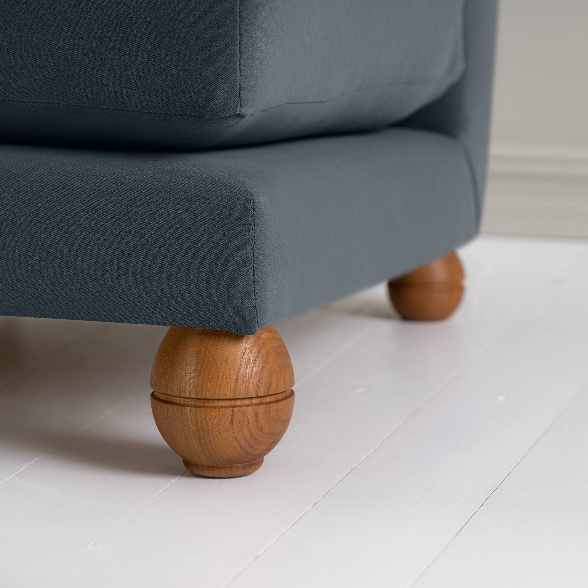  Perch Armchair close-up detail of the playful spherical timber foot by NiX. 