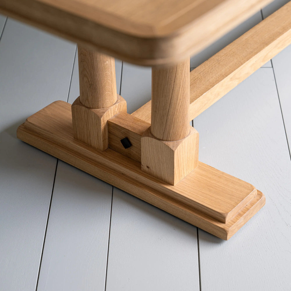 Tuck In rectangular dining table in oak with strong foot design, manufactured by NiX by Nicola Harding & Co.