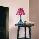 Ditsy Ceramic Table Lamp Base in Sea Blue Base On a Black Side Table With Some Boooks- Nicola Harding