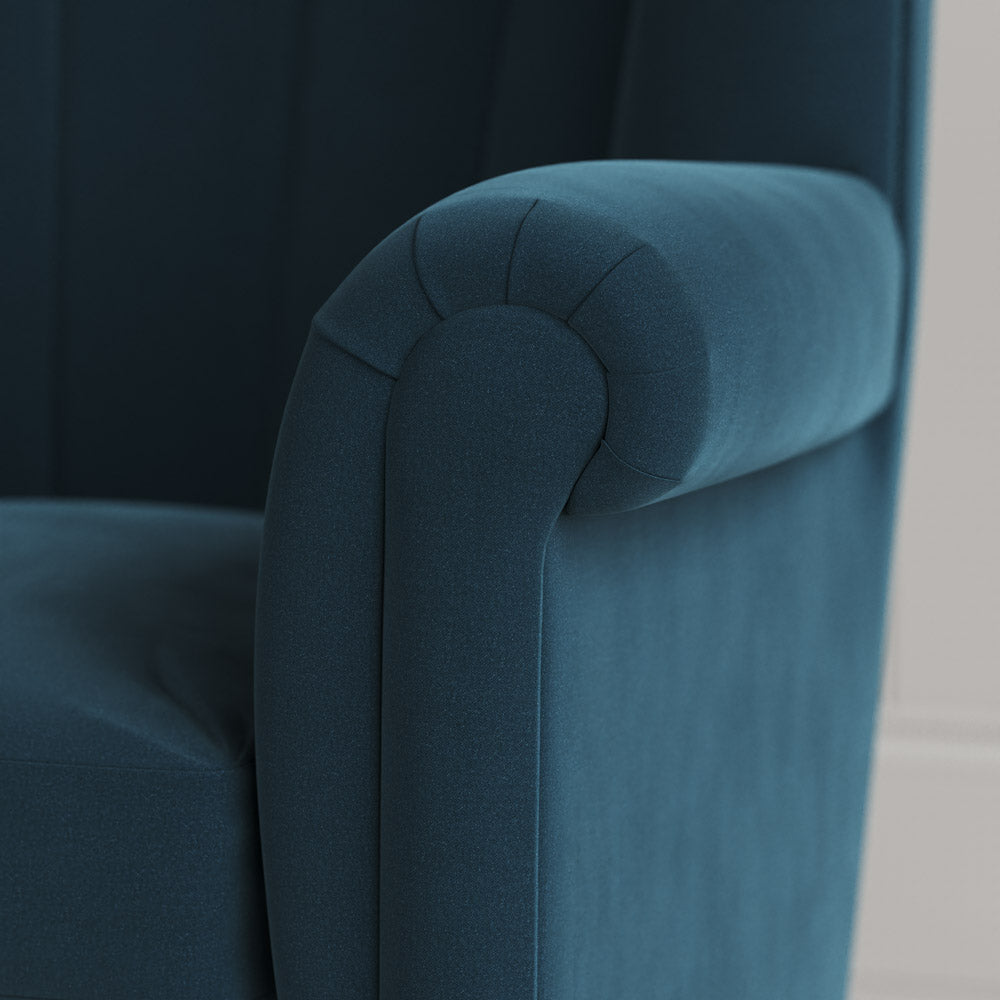 Time Out Armchair close-up detail of the rolled scroll arm and aegean velvet upholstery by NiX.