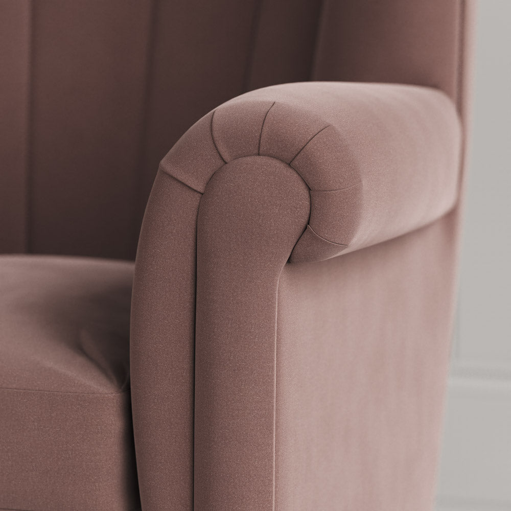 Time Out Armchair close-up detail of the rolled scroll arm and dusky pink velvet upholstery by NiX. 