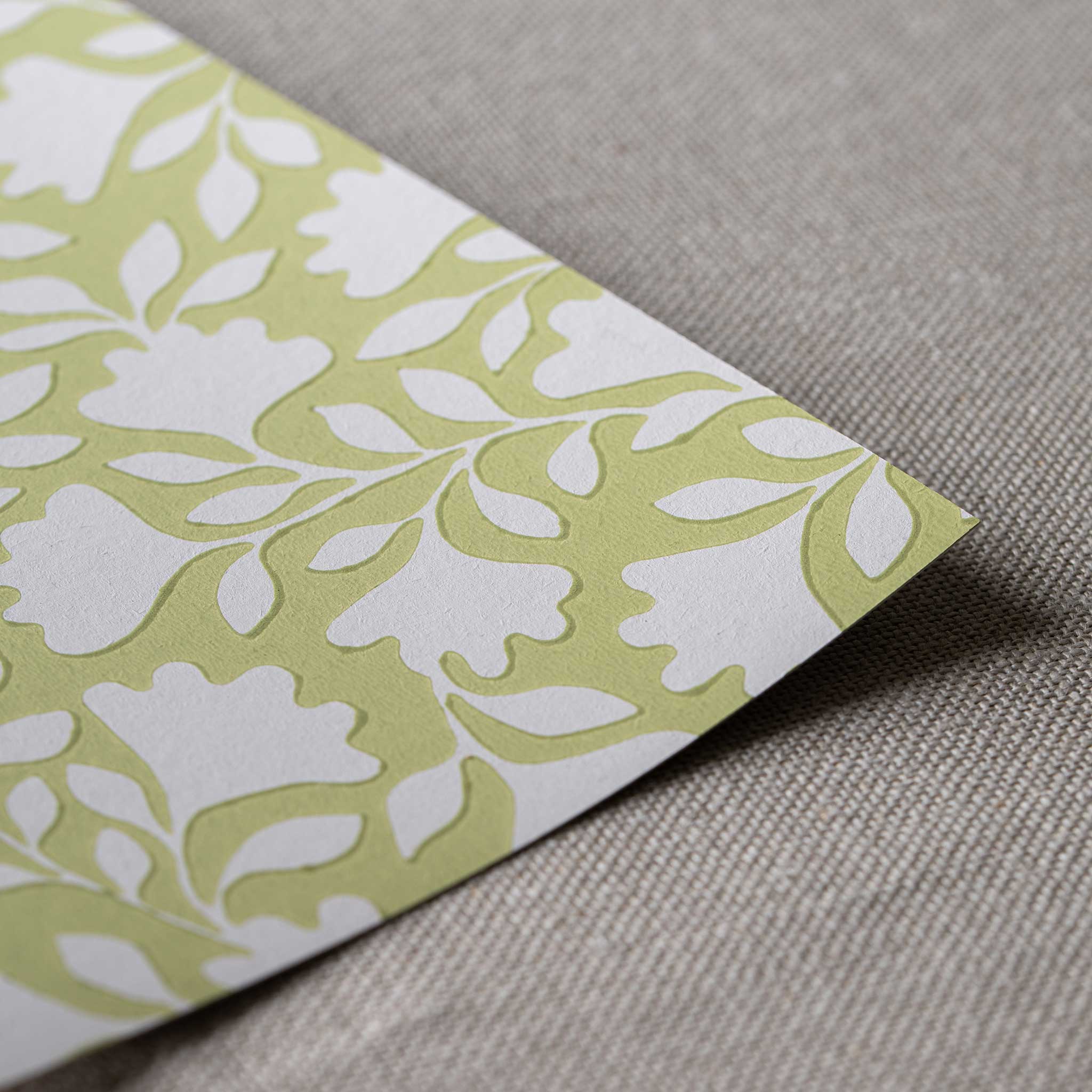 Close-up of the fine, neat edge of Ginkgo wallpaper in Moss Green, designed by Nicola Harding. 